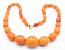 Baltic amber necklace made up of 33 graduated oval beads, largest 19.7 x 16.3mm, smallest 6.9 x 9.
