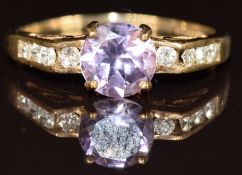 A 9ct gold ring set with a round cut amethyst and diamonds, 1.9g, size Q