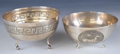 Two silver bowls, both raised on three feet, one with Greek key style decoration, both marked 830,