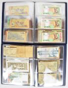 Two albums of all world banknotes including mint Queen Elizabeth II £5 notes, £1 military note,
