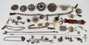 A collection of silver including Victorian Albert with tassel charm, two bracelets, twelve charms,