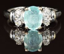 An 18k white gold ring set with an oval cut Paraiba tourmaline of approximately 0.8ct and