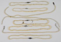 Eight strands of cultured pearl necklaces, four with silver clasps