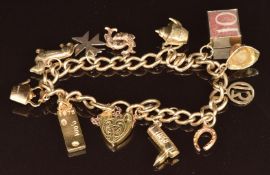 A 9ct gold charm bracelet with eleven 9ct gold charms including dog, fish, horseshoe and 10 shilling