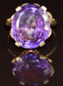 An 18ct gold ring set with an oval mixed cut synthetic sapphire, 6g, size N