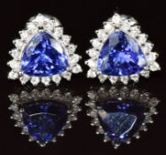 A pair of platinum earrings set with trillion cut tanzanites surrounded by diamonds, 4.4g