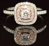 A 14ct gold ring set with diamonds, the largest approximately 0.29ct, surrounded by two rows of