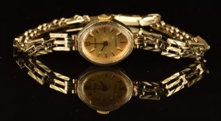 Accurist 9ct gold ladies wristwatch with gold hands, hour marker and dial and quartz movement, on