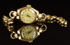 Winegartens 9ct gold ladies wristwatch with gold hands and hour markers, silver dial and signed 17