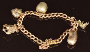 A 9ct gold charm bracelet with five charms including a gilt Stanhope in the form of an anchor, cross