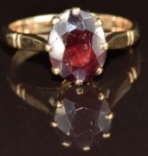 A 9ct gold ring set with an oval cut garnet, 3.1g, size M