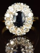 An 18ct gold ring set with an oval cut sapphire of approximately 1ct surrounded by diamonds of