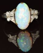 A platinum ring set with an opal cabochon and diamonds to the shoulders, 3.5g, size M