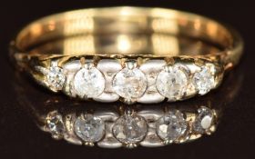 An 18ct gold ring set with five diamonds, 2.9g, size Q