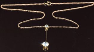 A c1910 15ct gold pendant set with two aquamarines, on 9ct gold necklace chain, 3.4g, 40cm