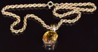 A 9ct gold pendant set with an oval cut citrine on 9ct gold rope twist chain, 15.1g, 38cm