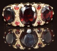 A 9ct gold ring set with garnets, 4.3g, size Q