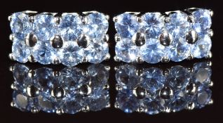 A pair of 18k white gold earrings each set with eight round cut Ceylon sapphires, the total sapphire