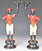 Pair of bronze or similar Blackamoor candlesticks formed as figures holding sconces aloft, height