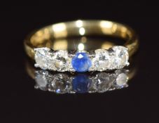 A 22ct gold wedding band / ring set with a round cut sapphire of approximately 0.16ct and four round