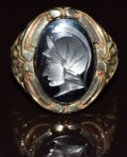 A 9ct gold ring set with a hematite intaglio depicting a warrior, 9.8g, size U