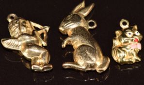 Three 9ct gold charms, a cat, hare and Cupid, 3.6g