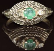 An 18ct white gold ring set with an emerald and diamond in a rope twist setting (missing a diamond),