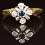 An 18ct gold ring set with a sapphire and diamonds, 2.2g, size L
