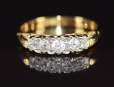 An 18ct gold ring set with five graduated diamonds, 2.7g, size K