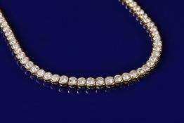 An 18ct gold necklet set with one hundred and eleven round brilliant cut diamonds, largest diamond