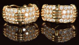 A pair of 18k gold earrings each set with 28 round cut diamonds, the total diamond weight