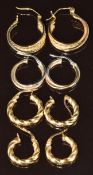 A pair of 14k gold hoop earrings (3.8g) and three pairs of 9ct gold hoops (3.1g)