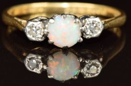An 18ct gold ring set with an opal cabochon and two diamonds, 2.3g, size P