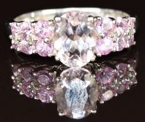 A 9k white gold ring set with an oval cut morganite and pink sapphires, 2.5g, size M