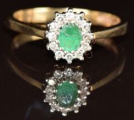 A 9ct gold ring set with an oval emerald surrounded by diamonds, 3.2g, size Q
