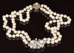 A double strand of cultured pearls with 14k white gold pendant set with diamonds and further