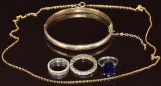A yellow metal bangle (tests as 9ct gold, 8.2g), 9ct gold chain (3.2g), a white metal ring marked 9k
