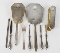 Art Deco hallmarked silver dressing table set comprising hand mirror, two brushes and comb mount,