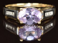 A 9ct gold ring set with an oval cut amethyst and diamonds, 2.4g, size N