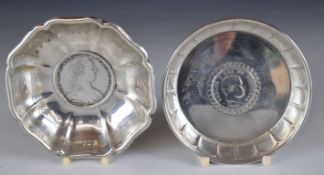 Two silver coin based dishes comprising one set with Maria Theresia coin, marked to bowl 800, the