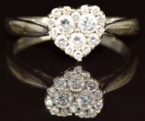An 18ct white gold ring set with diamonds in a heart setting, 3.1g, size N