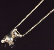 A 9ct gold pendant in the form of a bear, on a 9ct gold chain, 5.9g
