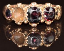 A 9ct rose gold ring set with four garnets (one missing), Birmingham 1916, 2.5g, size N