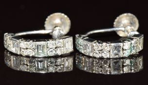 A pair of 9ct white gold earrings set with baguette cut and round cut diamonds, believed to have