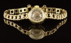 Unnamed 14ct ladies wristwatch with gold hands and hour markers, silver dial and unsigned