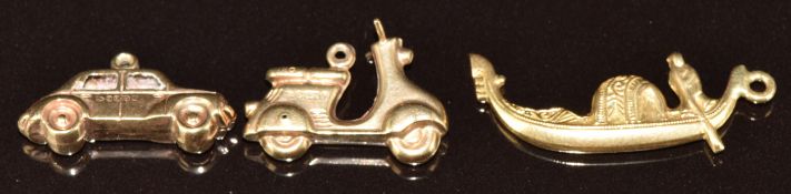 An 18ct gold charm in the form of a gondola (1.3g) and two 9ct gold charms in the form of a