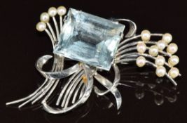 A 9ct white gold brooch set with an emerald cut aquamarine of approximately 15ct and pearls, maker C