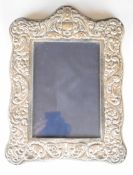 Modern Elizabeth II hallmarked silver photograph frame with embossed decoration and easel back, to