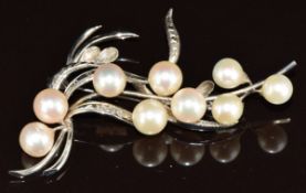 A 14k white gold brooch set with cultured pearls in the style of Mikimoto, 10.5g, 6.5cm