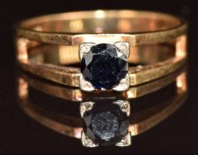An 18ct gold ring set with a round cut sapphire, 3.4g, size M